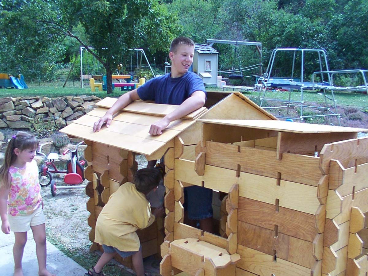 kids building a builder board playhouse